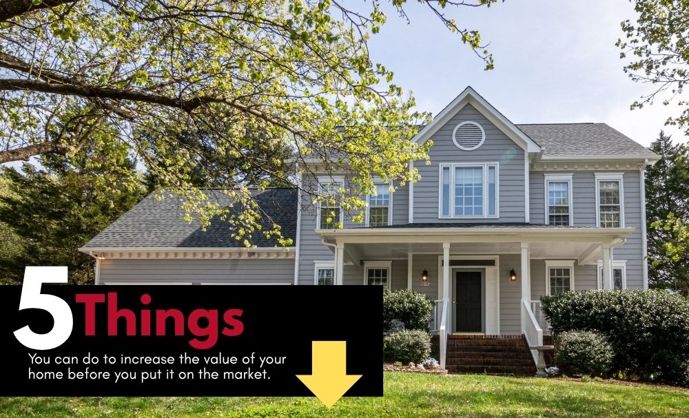 Two-story gray house with a front porch; black banner in the corner reads '5 Things' about increasing home value, with a yellow downward arrow.